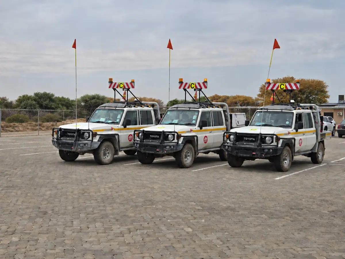 Three light vehicles fitted with buggy whips and beacons